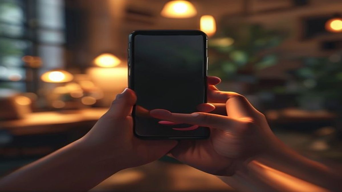 Two hands holding a smartphone during a call in a warm room